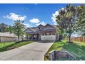 House with a two-car garage and landscaped yard at 151 Crosscreek Ln, Angier, NC 27501