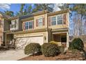 Two-story townhome with a double-car garage, and landscaping at 320 Westgrove Ct, Durham, NC 27703