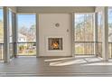 A cozy outdoor fireplace with wood mantel in a large, covered back deck at 3304 Cheswick Dr, Raleigh, NC 27609