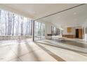 Bright and airy living room featuring floor to ceiling windows, fireplace and concrete floors at 6358 Pathway Ct Ct, Chapel Hill, NC 27516