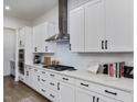 White kitchen cabinets, quartz countertops, and stainless steel appliances at 678 The Parks Dr, Pittsboro, NC 27312