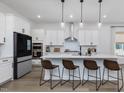 Modern kitchen with white cabinets, quartz countertops, and an island at 678 The Parks Dr, Pittsboro, NC 27312