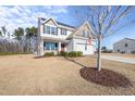 Two-story house with gray siding, solar panels, and a red front door at 70 Kinsale Ct, Fuquay Varina, NC 27526