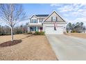 Two-story house featuring gray siding, solar panels, and a landscaped yard at 70 Kinsale Ct, Fuquay Varina, NC 27526