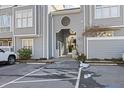 Building entrance with walkway and parking area at 720 Bishops Park Dr # 305, Raleigh, NC 27605