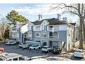 Gray building exterior with ample parking and landscaping at 720 Bishops Park Dr # 305, Raleigh, NC 27605
