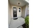 Inviting front porch with stylish black door and matching hardware, offering a warm welcome at 7205 Ladbrooke St, Raleigh, NC 27617