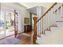 Bright entryway with hardwood floors, staircase, and view into backyard at 76527 Rice, Chapel Hill, NC 27517