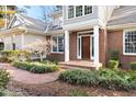 Inviting front entrance with brick steps and walkway, surrounded by greenery at 76527 Rice, Chapel Hill, NC 27517