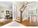 Hardwood staircase with white risers and decorative trim leading to the second floor at 76527 Rice, Chapel Hill, NC 27517