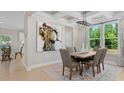 Bright dining room featuring a large wooden table and modern light fixture at 802 Brookfield Dr, Gibsonville, NC 27249