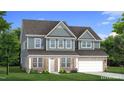 Two-story home with gray siding, brick accents, and a two-car garage at 806 Brookfield Dr, Gibsonville, NC 27249
