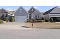 Two-story home with attached garage and landscaping at 821 Blackfriars Loop, Cary, NC 27519
