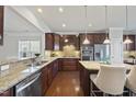 Spacious kitchen with granite countertops and stainless steel appliances at 821 Blackfriars Loop, Cary, NC 27519