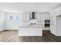 Bright, modern kitchen features white cabinets, stainless steel appliances, island, and updated countertops at 1029 Dillon Lake Dr, Knightdale, NC 27545