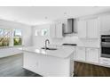 Bright, modern kitchen features white cabinets, stainless steel appliances, island, and updated countertops at 1029 Dillon Lake Dr, Knightdale, NC 27545