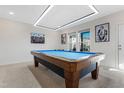 Spacious game room with a pool table, modern lighting, and large windows at 1040 Myers Point Dr, Morrisville, NC 27560
