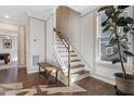 Elegant staircase with wooden railings and a built-in bench, leading to the upper level at 1040 Myers Point Dr, Morrisville, NC 27560