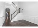 Elegant staircase with dark wood railing and white risers, leading to upper level at 1099 Talisker Way, Burlington, NC 27215