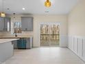 Gray kitchen cabinets, island, and sliding glass doors to deck at 1523 Alta Vista Ln, Graham, NC 27253