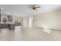Open living space with hardwood floors and modern ceiling fan at 1523 Alta Vista Ln, Graham, NC 27253