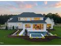 Aerial view of a luxury home featuring a private pool, patio, and well-manicured lawn at 1608 Legacy Ridge Ln, Wake Forest, NC 27587