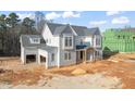 Two-story house under construction with gray siding, attached garage, and landscaping at 1609 Legacy Ridge Ln, Wake Forest, NC 27587