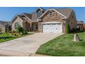Two-story brick house with a two car garage and driveway at 257 Macallan Dr, Burlington, NC 27215