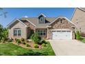 Brick house with a two-car garage and manicured lawn at 257 Macallan Dr, Burlington, NC 27215