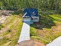 Aerial view of single Gathering home featuring a long driveway and ample green space at 5394 Salem Woods Dr # 16, Graham, NC 27253