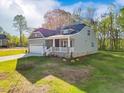 Two-story home featuring a white porch, attached garage, and lush lawn at 5394 Salem Woods Dr # 16, Graham, NC 27253