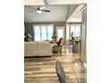Open concept living room and kitchen with high ceilings, and hardwood floors at 55 Running Deer Path, Timberlake, NC 27583