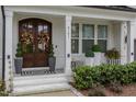 Elegant front entry with double doors and lush landscaping at 8101 Fergus Ct, Wake Forest, NC 27587