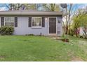 Charming gray duplex unit with a dark door and a grassy yard at 830 E Lenoir St, Raleigh, NC 27601