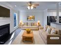 Virtually staged living room with fireplace and ample natural light at 1004 Cabin Hill Way, Garner, NC 27529