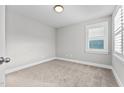 Spacious bedroom with neutral walls, carpet flooring, and a window with shutters at 104 Spruce Hollow Cir, Spring Lake, NC 28390