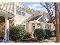 Beige townhome with stone accents and landscaping at 11215 Lofty Heights Pl, Raleigh, NC 27614