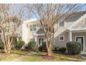 Two story townhome with tan siding and landscaping at 11215 Lofty Heights Pl, Raleigh, NC 27614