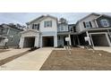 Charming townhomes featuring attached garages and modern architectural details at 128 Parker Ln, Mebane, NC 27302