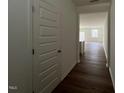 Inviting hallway featuring wood flooring, a neutral color palette, and an open concept design at 128 Parker Ln, Mebane, NC 27302