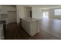 Modern kitchen boasts an island, sleek cabinetry, and stainless steel appliances at 128 Parker Ln, Mebane, NC 27302