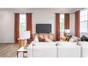 Living room with hardwood floors, large windows, and comfortable seating at 14 Virgo Dr, Angier, NC 27501