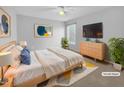 Virtually staged main bedroom with a bed, dresser, and plenty of space at 1611 Copper Cir, Mebane, NC 27302