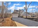 Two-story house with gray siding, white garage door, and driveway at 167 Black Cloud Dr, Louisburg, NC 27549