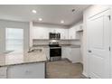 Modern kitchen with granite countertops and stainless steel appliances at 18 Virgo Dr, Angier, NC 27501