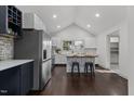 Spacious kitchen with white cabinets, stainless steel appliances, butcher block island, and vaulted ceilings at 205 Spring St, Louisburg, NC 27549