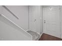 Inviting entryway featuring a carpeted staircase, hardwood floors, and fresh neutral paint at 2222 Alpine Rd, Durham, NC 27707