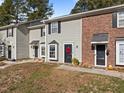 Three-unit townhouse complex with a neatly landscaped front lawn at 2222 Alpine Rd, Durham, NC 27707