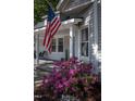Inviting front porch with American flag, seating, and lush landscaping at 223 N Main St, Wendell, NC 27591
