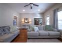 Bright living room featuring neutral furniture, hardwood floors, and recessed lighting at 223 N Main St, Wendell, NC 27591
